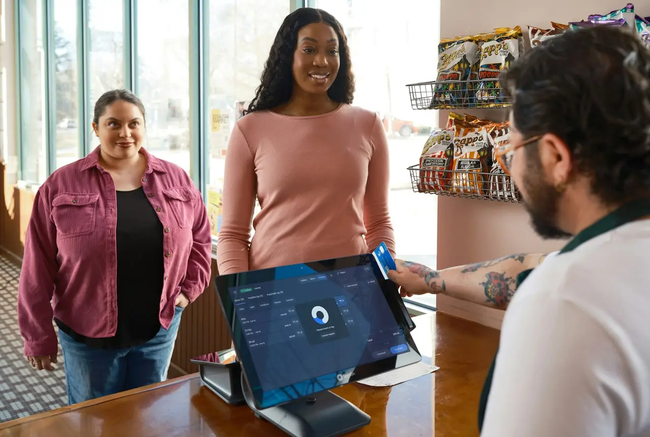 Clientas pagando en el mostrador de una tienda con un punto de venta